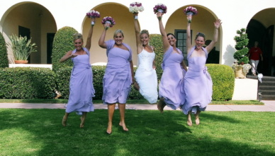 Bride and Bridesmaids jumping in the air in a grassy area