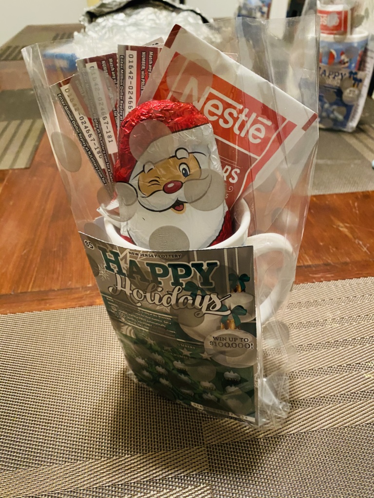 Christmas themed Hot Chocolate Mug with NJ Lottery Tickets, Nestle Instant Hot Chocolate with Marsmallow envelopes and a Chocolate Santa