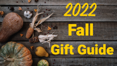 Fall squash, pumpkins and corn on a wood floor or patio with 2022 Fall Gift Guide in yellow on the right hand side